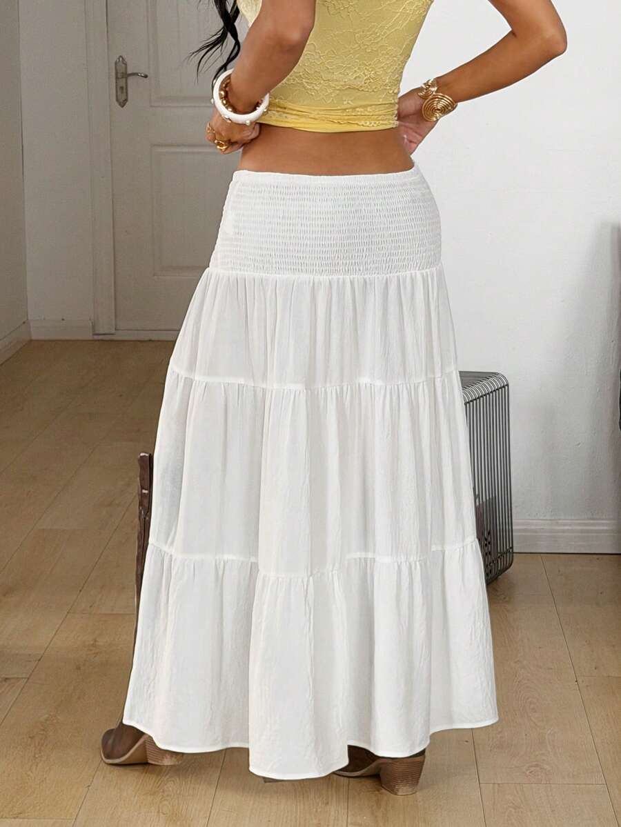 Women's black low waist split thigh long skirt featuring semi-sheer textured fabric and a flared skinny fit.