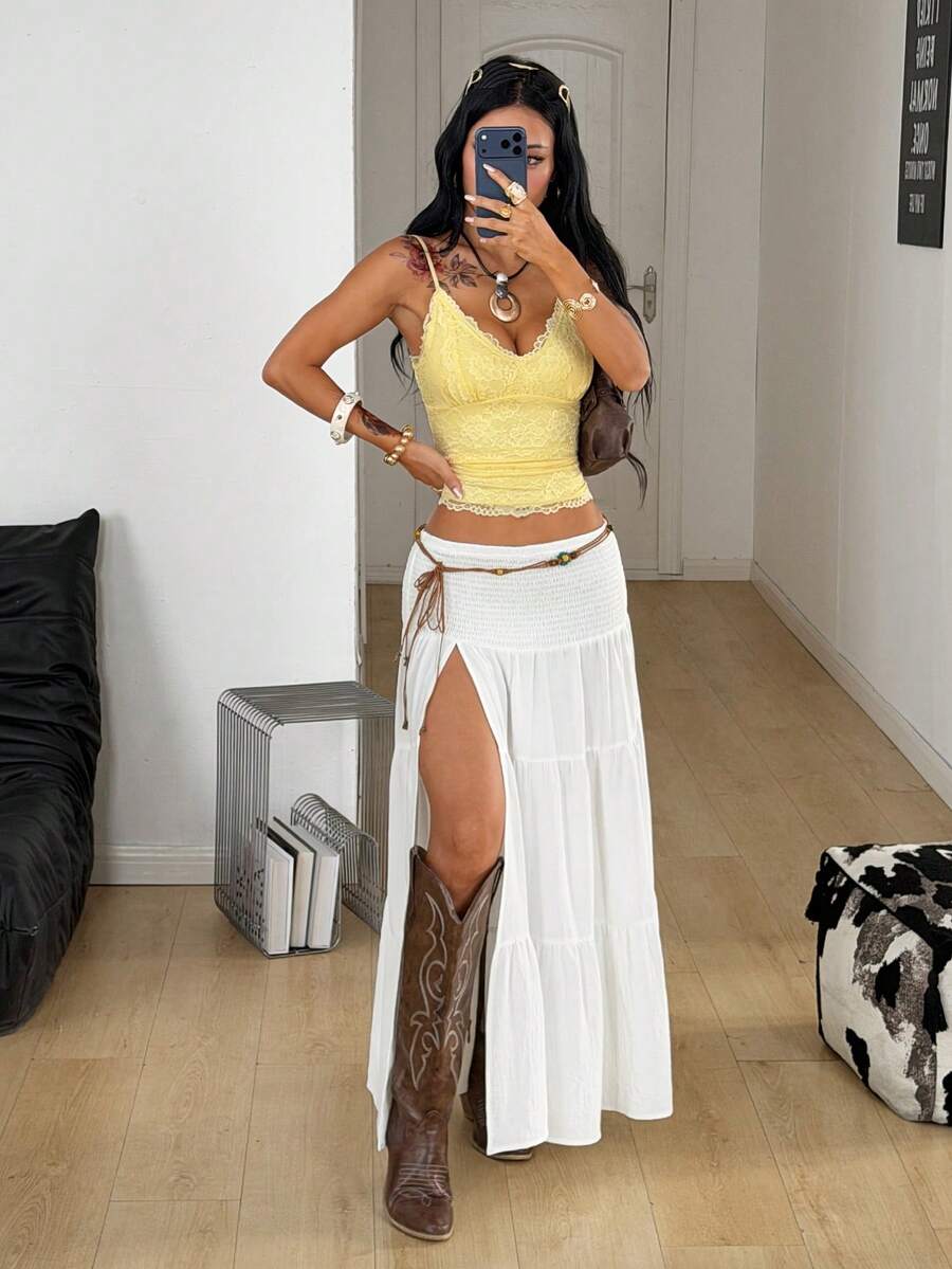 Women's black low waist split thigh long skirt featuring semi-sheer textured fabric and a flared skinny fit.