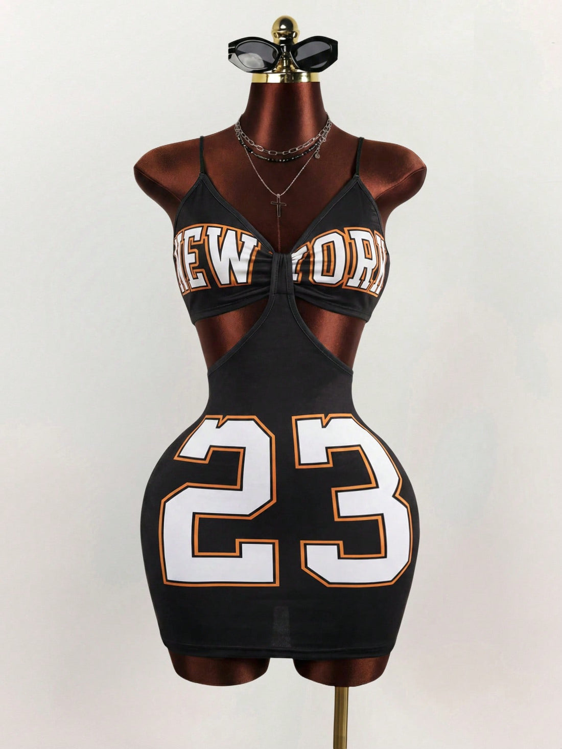Women's black letter print cami mini dress with spaghetti straps and a slim fit pencil silhouette.
