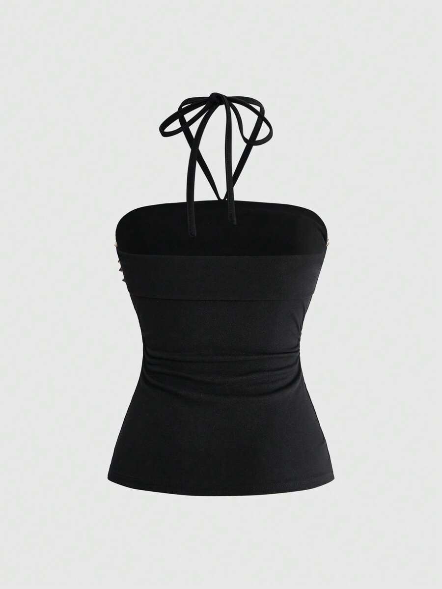 Women's sleeveless halter cropped camisole top in black with graphic slogan print and studded detailing.