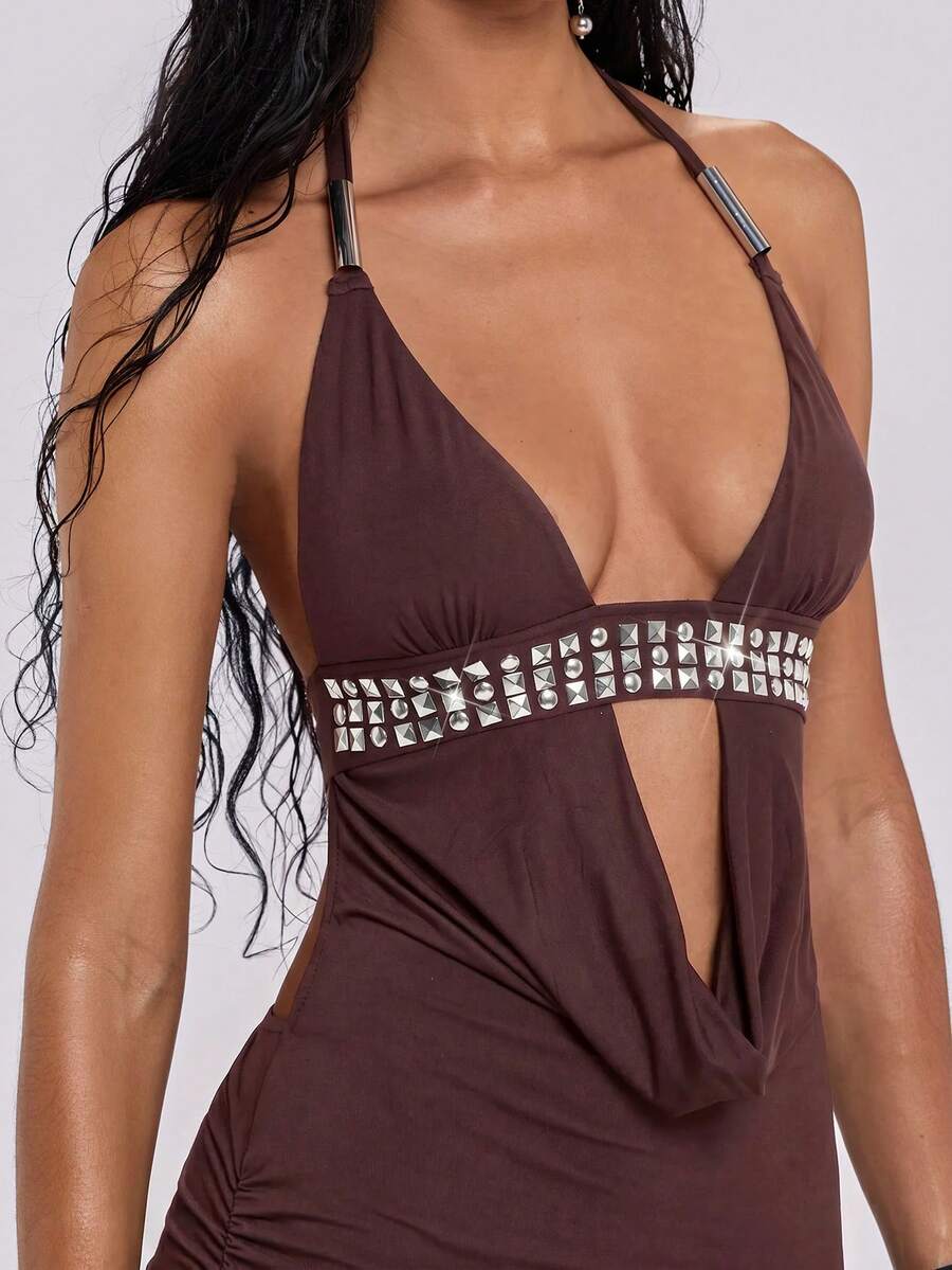 Sleeveless halter backless mini bodycon dress with high waist and tie-back detailing.