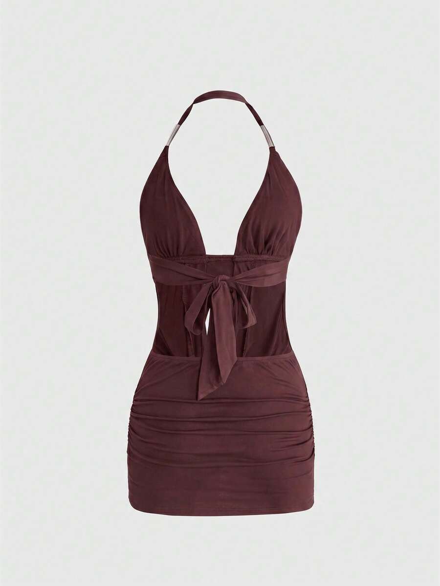 Sleeveless halter backless mini bodycon dress with high waist and tie-back detailing.