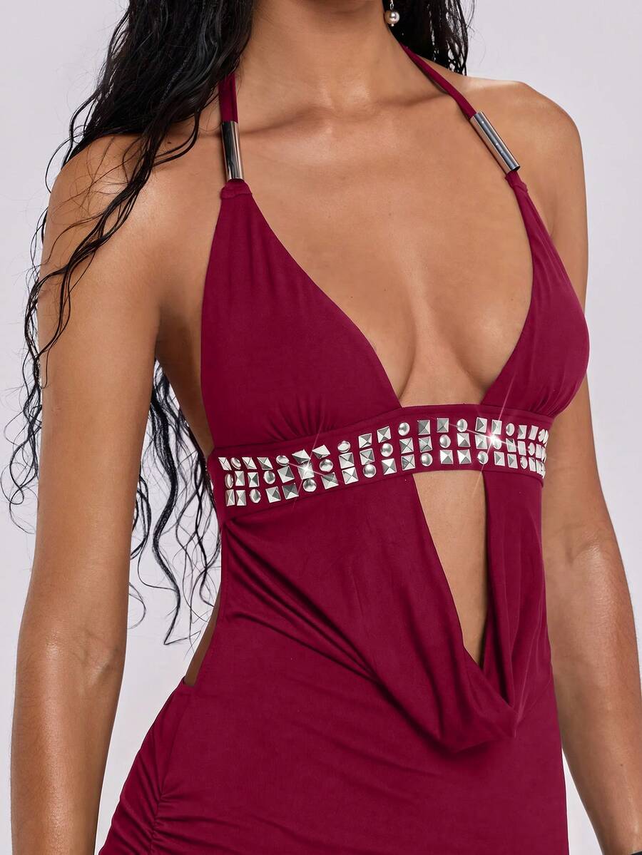 Sleeveless halter backless mini bodycon dress with high waist and tie-back detailing.