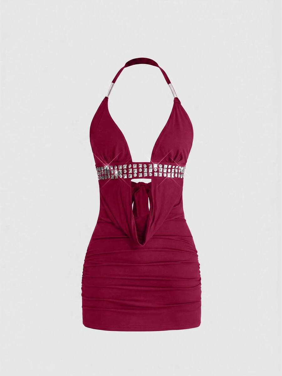 Sleeveless halter backless mini bodycon dress with high waist and tie-back detailing.