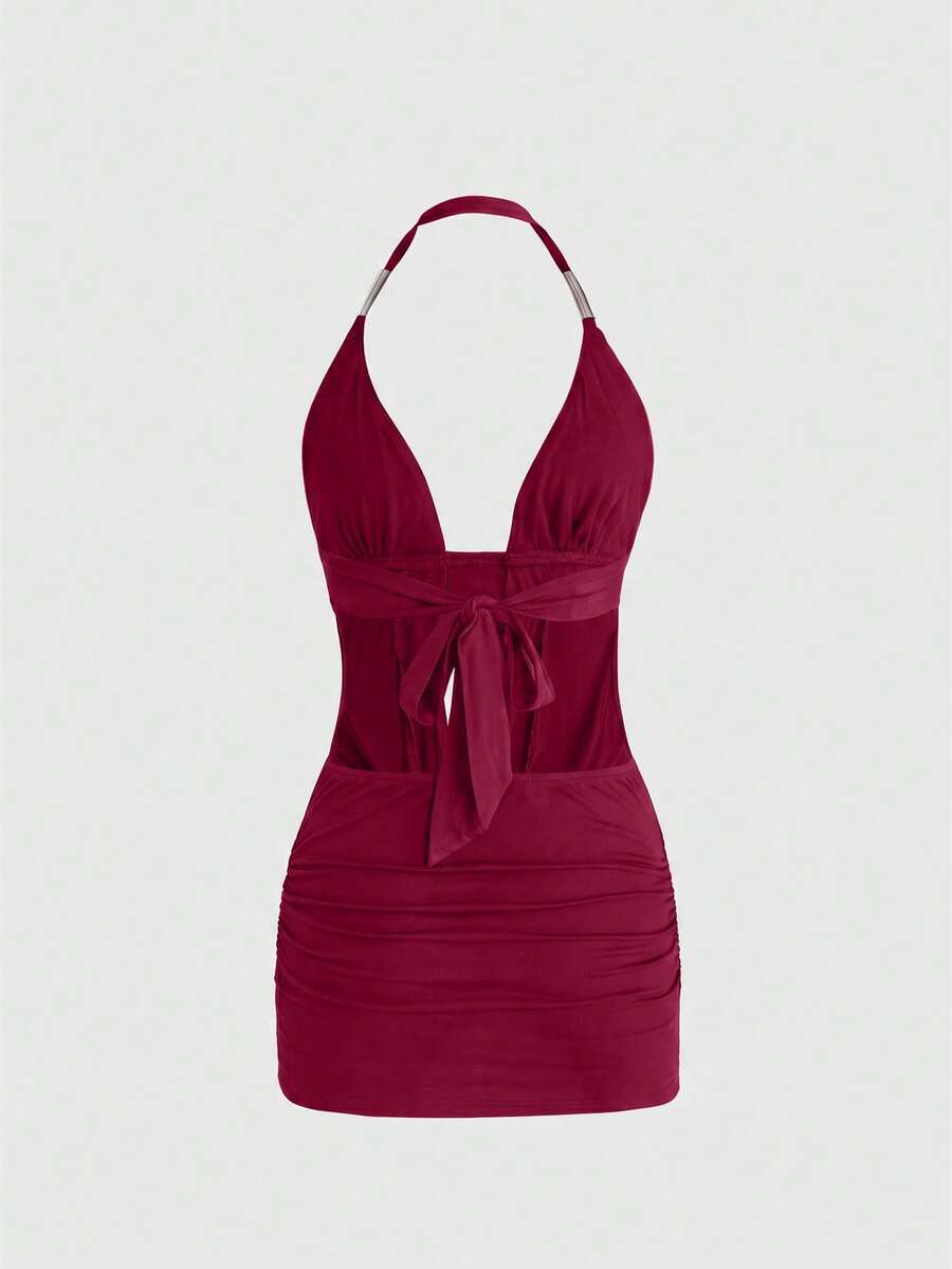 Sleeveless halter backless mini bodycon dress with high waist and tie-back detailing.