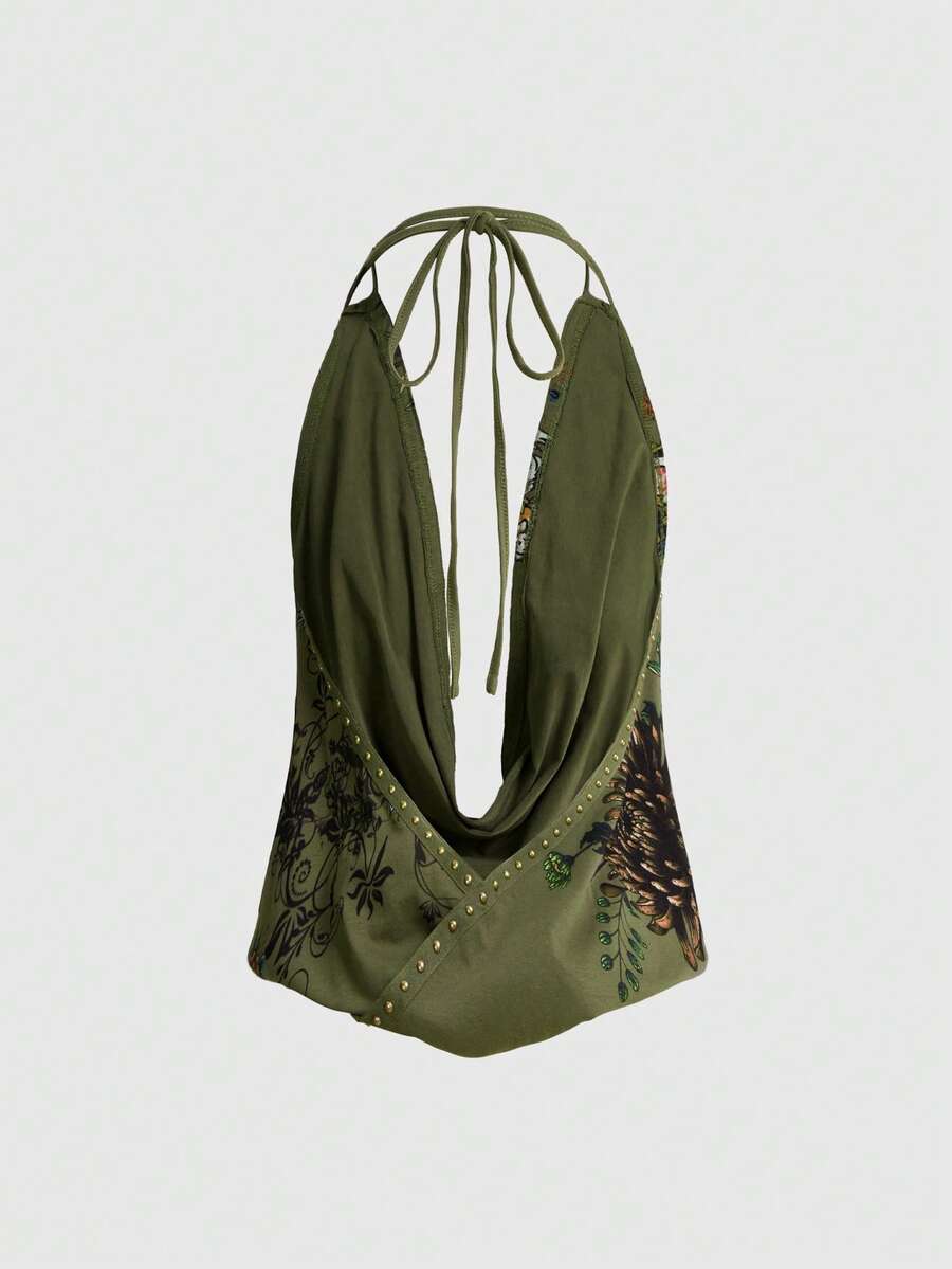 Women's black backless halter crop top featuring a V-neckline, tie-back detail, and asymmetrical hem.