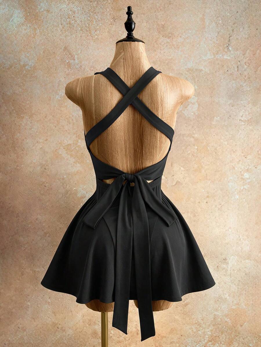 Sleeveless black halter mini dress for women featuring a high waist, A-line flared hem, and criss cross details.