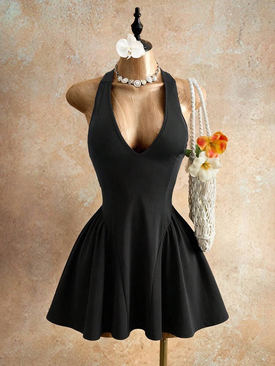 Sleeveless black halter mini dress for women featuring a high waist, A-line flared hem, and criss cross details.
