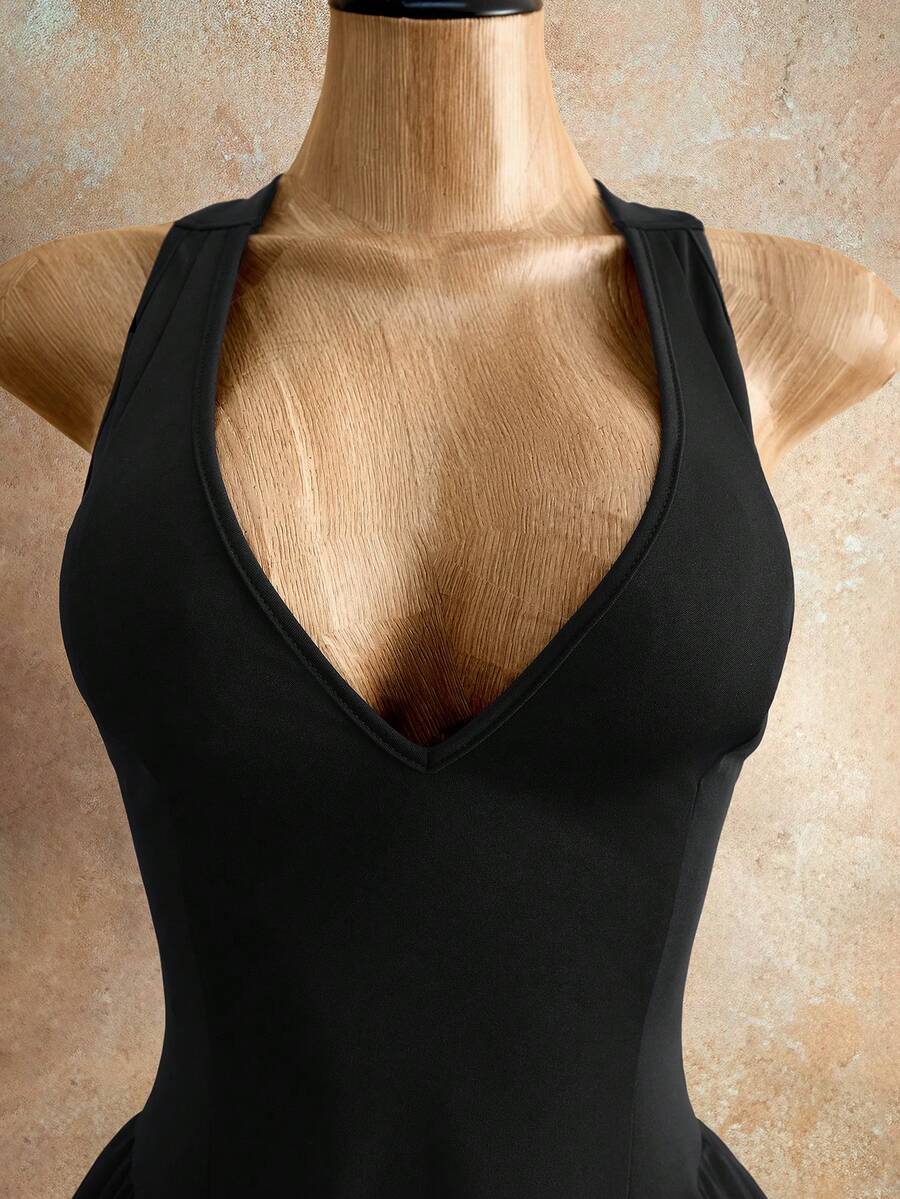 Sleeveless black halter mini dress for women featuring a high waist, A-line flared hem, and criss cross details.