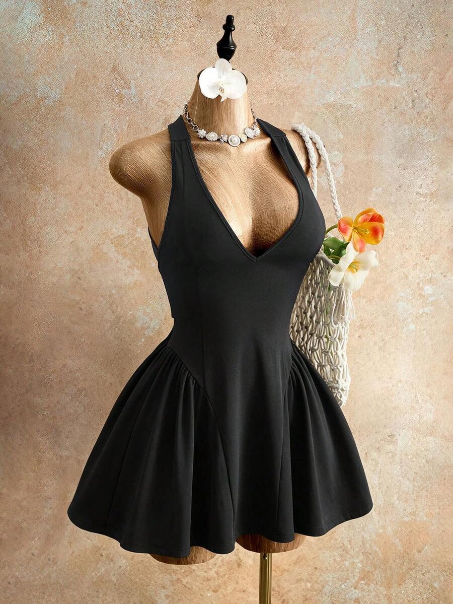 Sleeveless black halter mini dress for women featuring a high waist, A-line flared hem, and criss cross details.