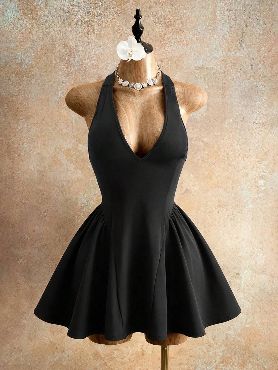 Sleeveless black halter mini dress for women featuring a high waist, A-line flared hem, and criss cross details.