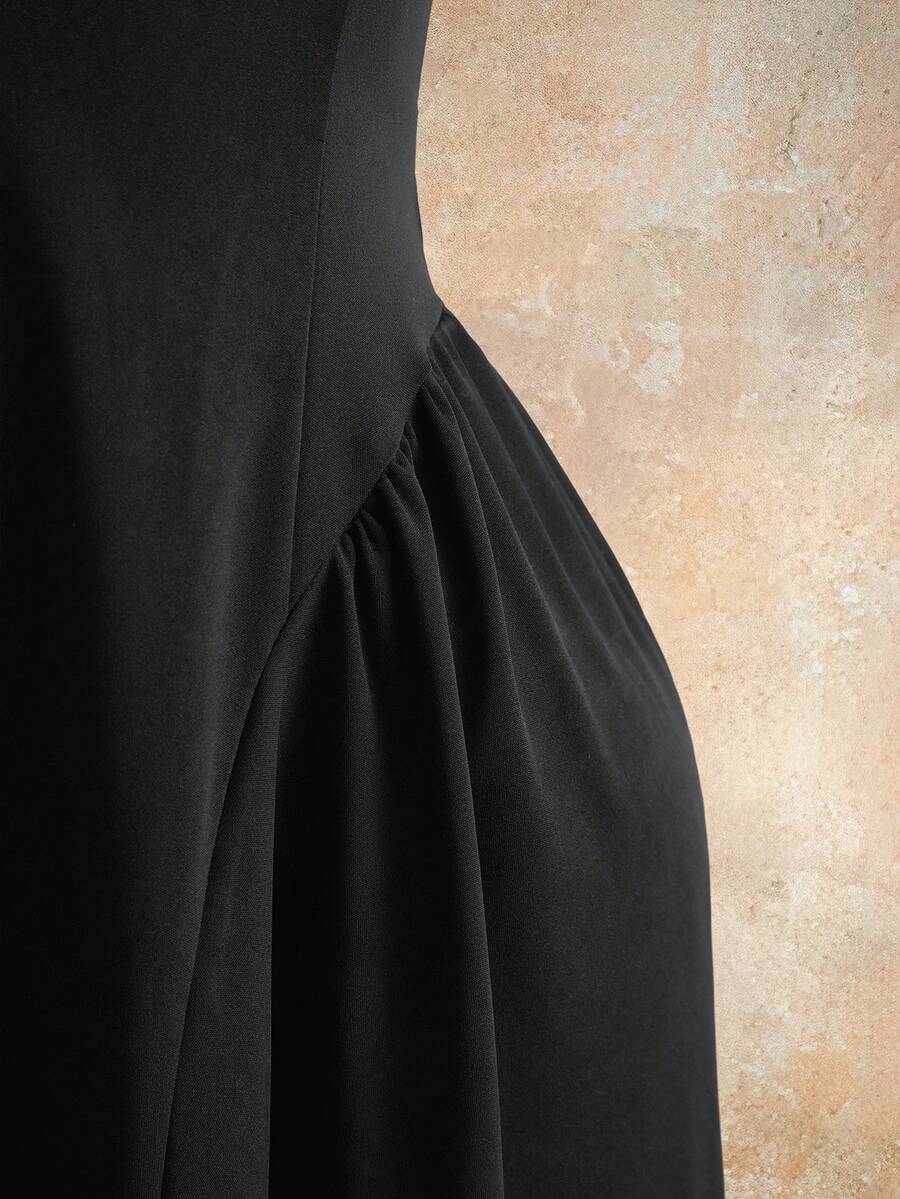 Sleeveless black halter mini dress for women featuring a high waist, A-line flared hem, and criss cross details.