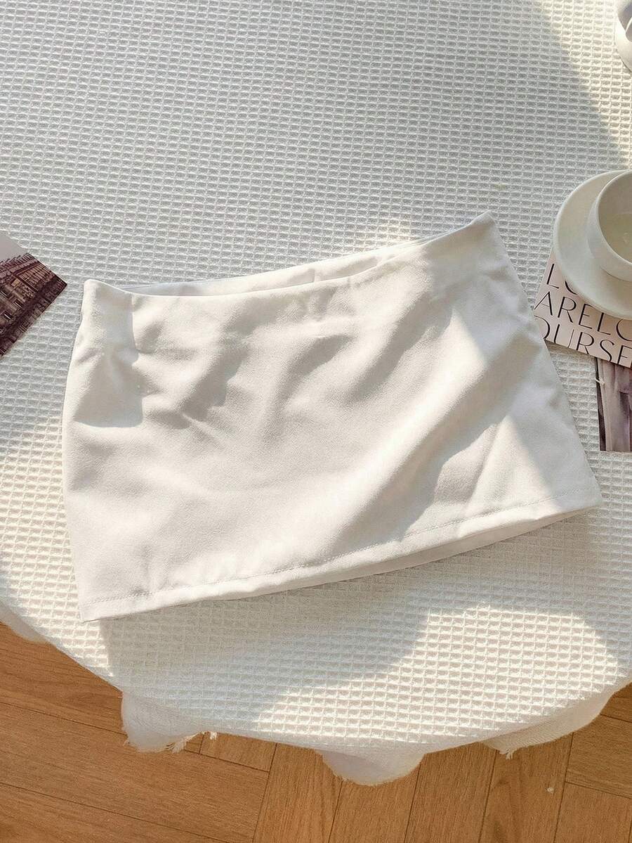 Women's white 100% cotton low waist mini skirt featuring a tropical print and zipper detail.