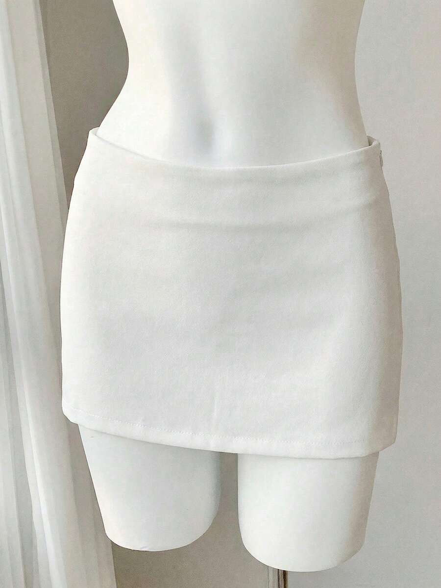 Women's white 100% cotton low waist mini skirt featuring a tropical print and zipper detail.