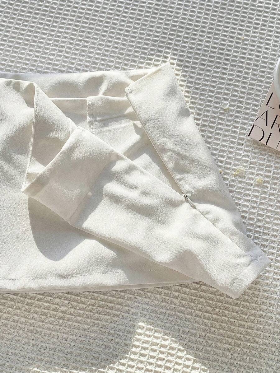 Women's white 100% cotton low waist mini skirt featuring a tropical print and zipper detail.