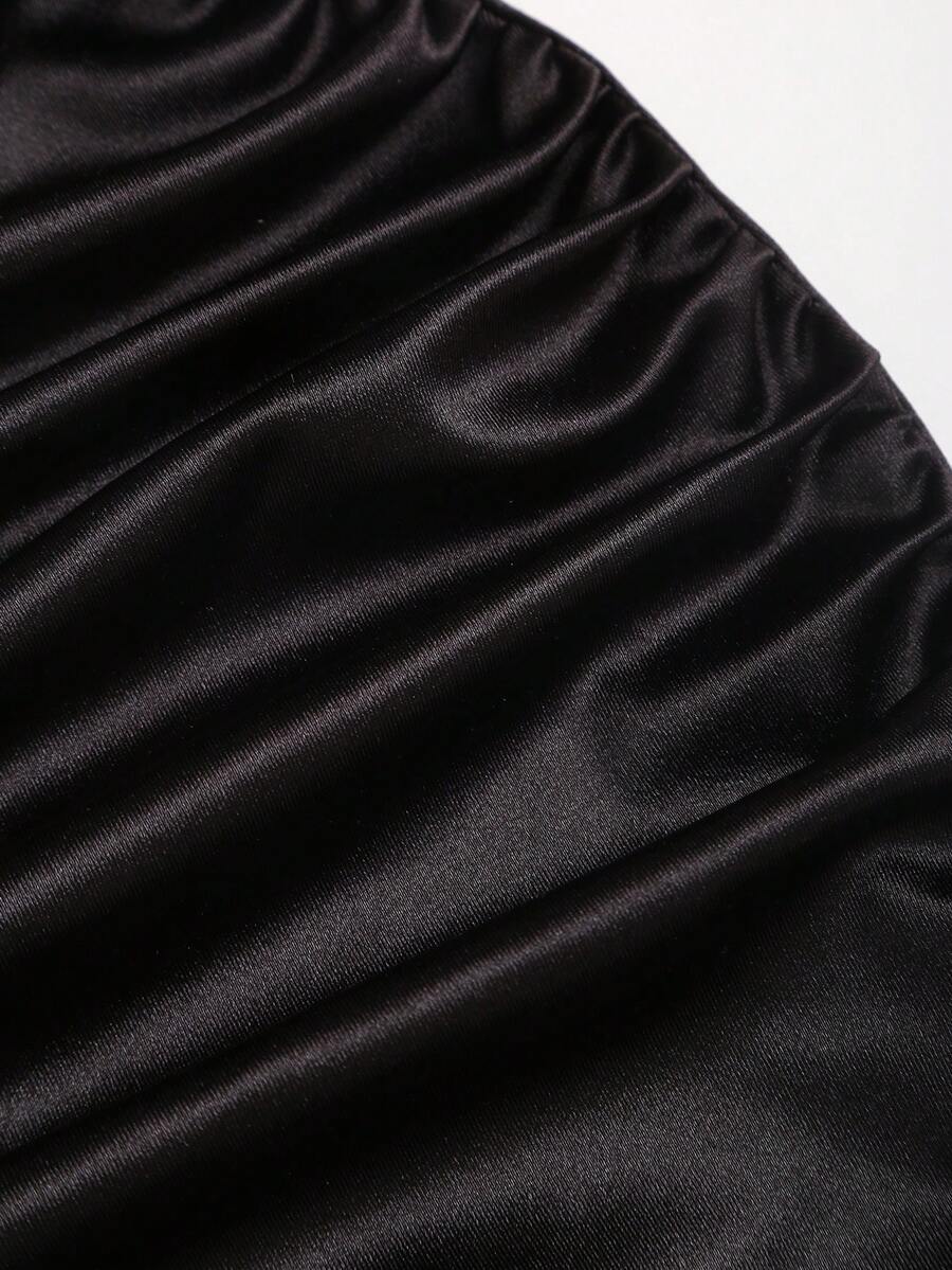 Women's black strapless bodycon mini dress featuring ruched detailing, cut-out design with ring accent, mid-waist pencil hem, and slim fit knitted stretch fabric.