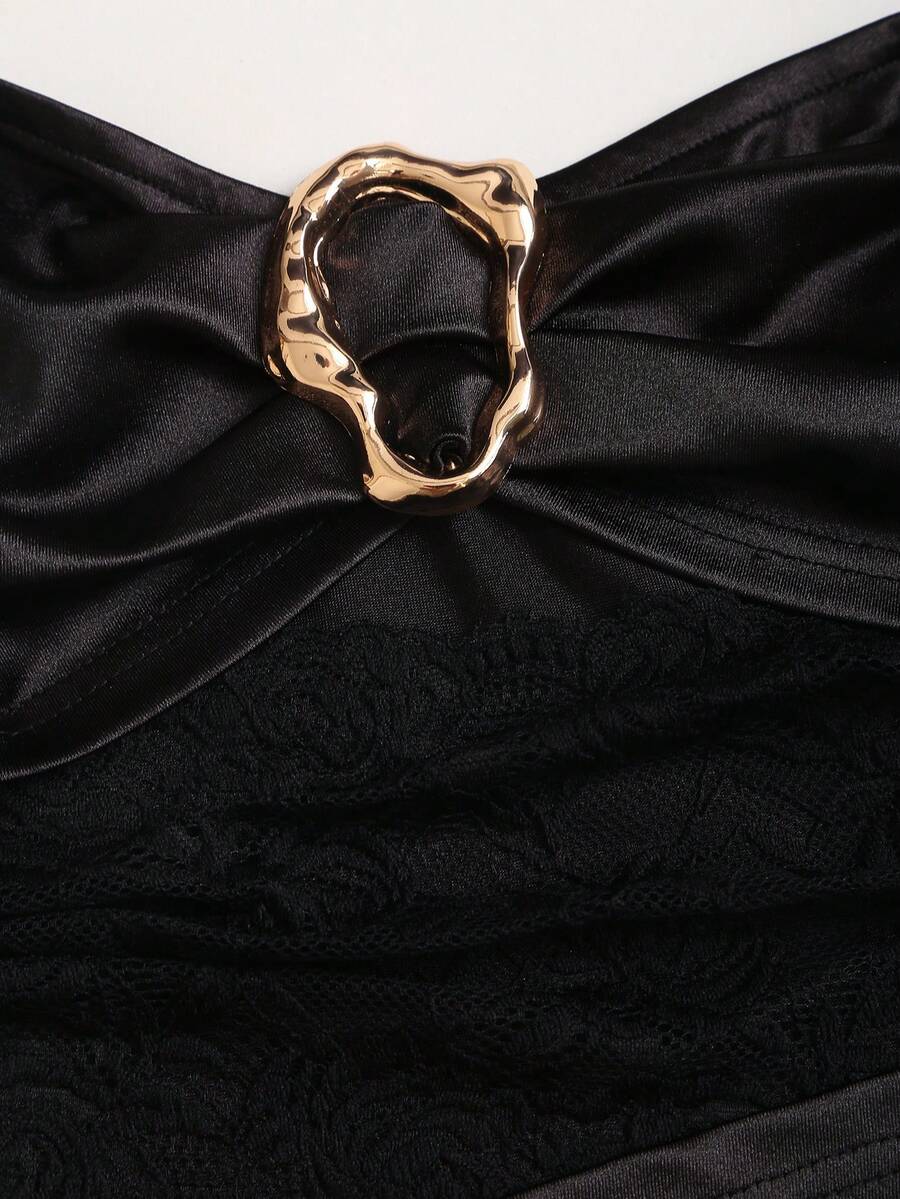 Women's black strapless bodycon mini dress featuring ruched detailing, cut-out design with ring accent, mid-waist pencil hem, and slim fit knitted stretch fabric.