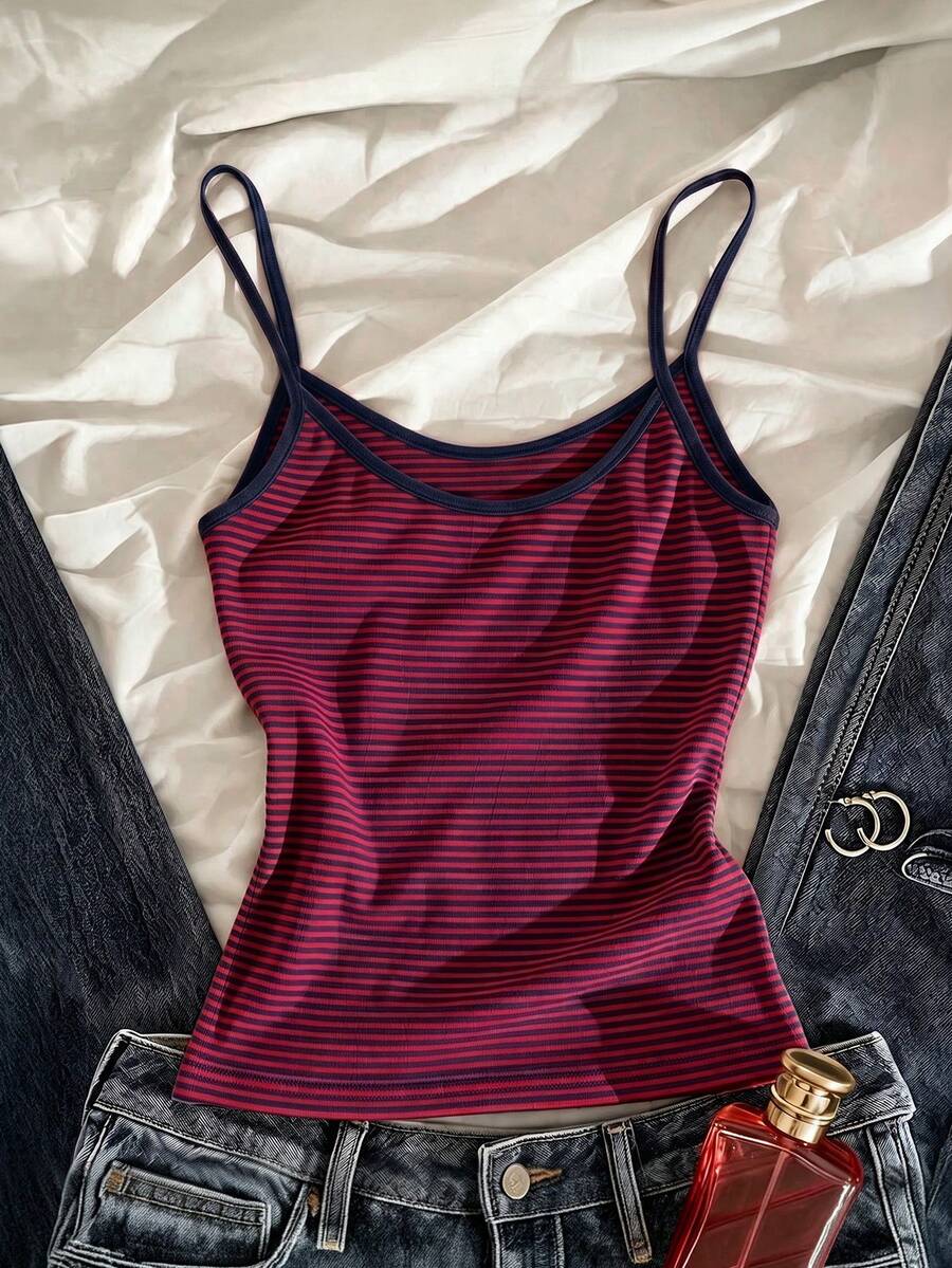Women's pink striped crop camisole featuring criss cross spaghetti straps and slim fit design.