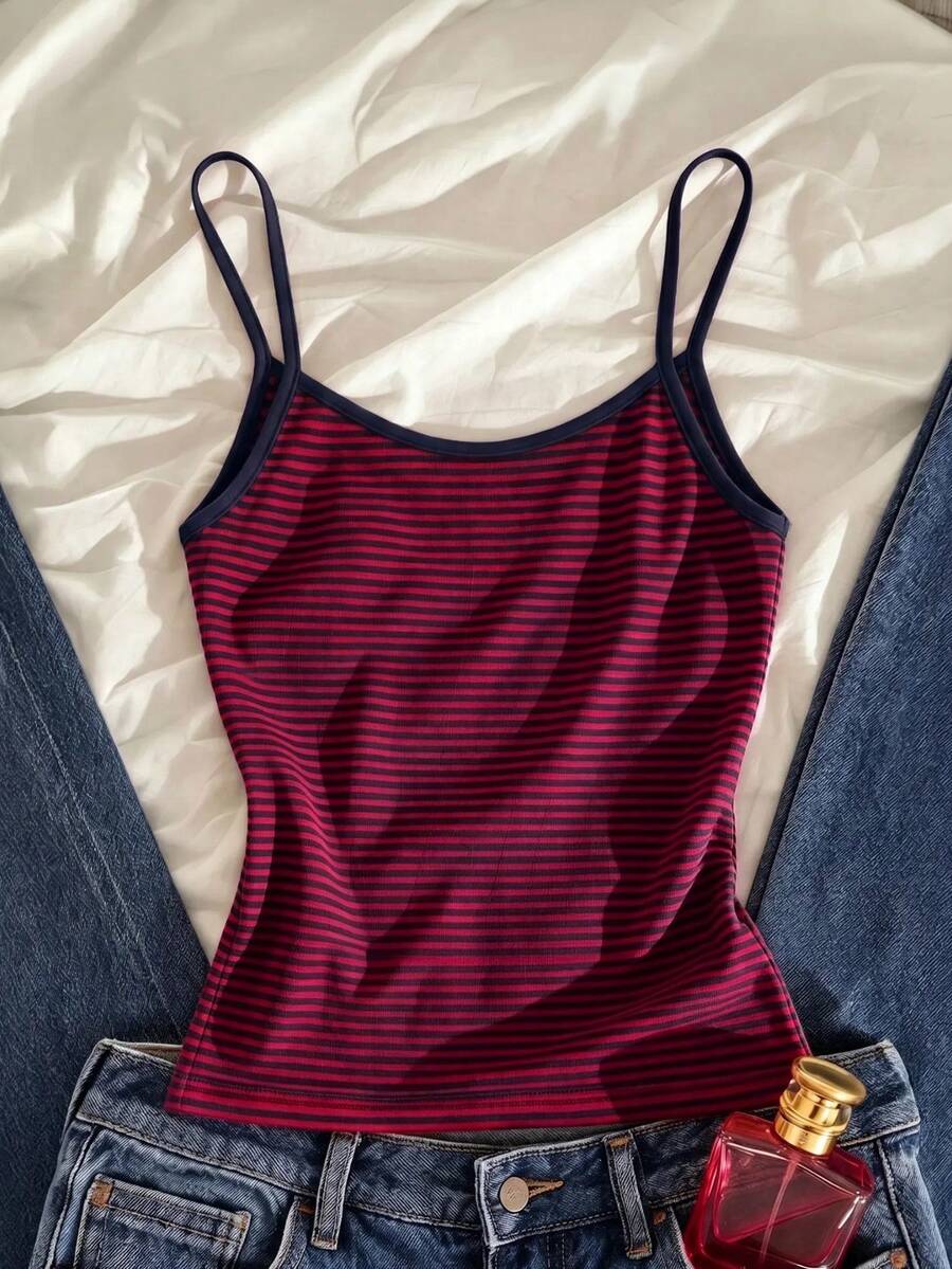 Women's pink striped crop camisole featuring criss cross spaghetti straps and slim fit design.
