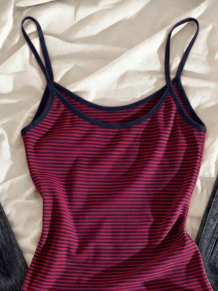Women's pink striped crop camisole featuring criss cross spaghetti straps and slim fit design.
