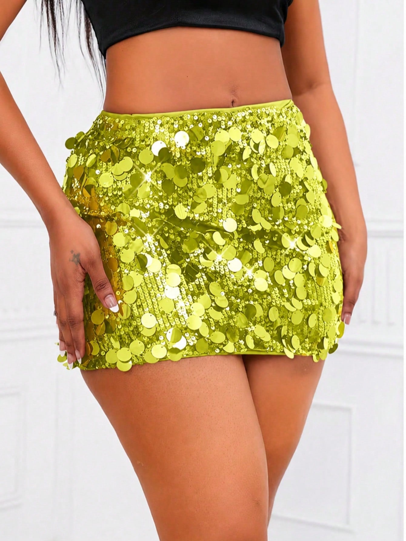 Women's high waist black sequin bodycon mini skirt featuring sparkling embellishments, unlined polyester fabric, ideal for night out and party wear.