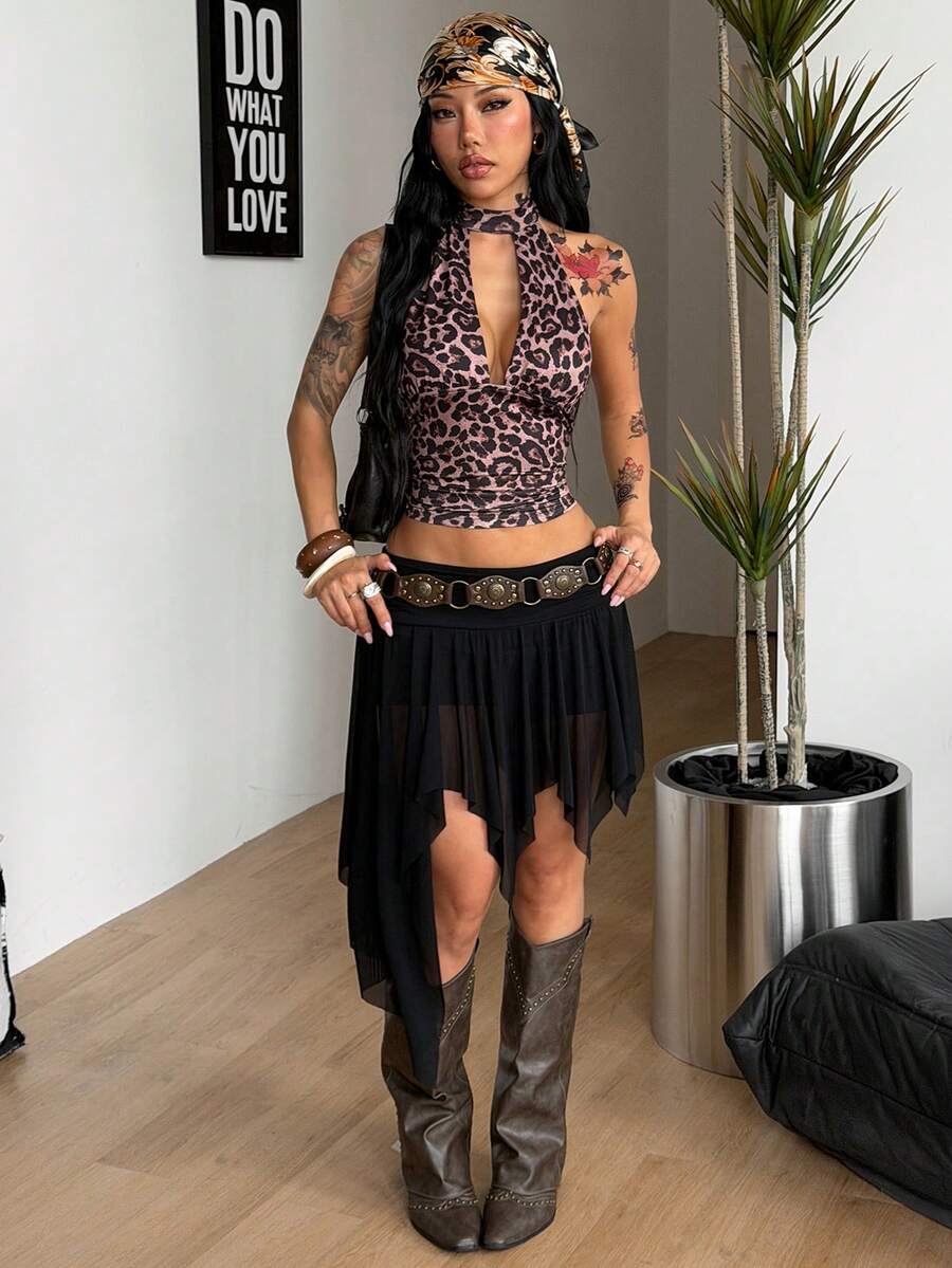 Women's asymmetrical ruffle skort with low waist, hollow out details, and lined body in knitted stretch fabric for beach and summer wear.