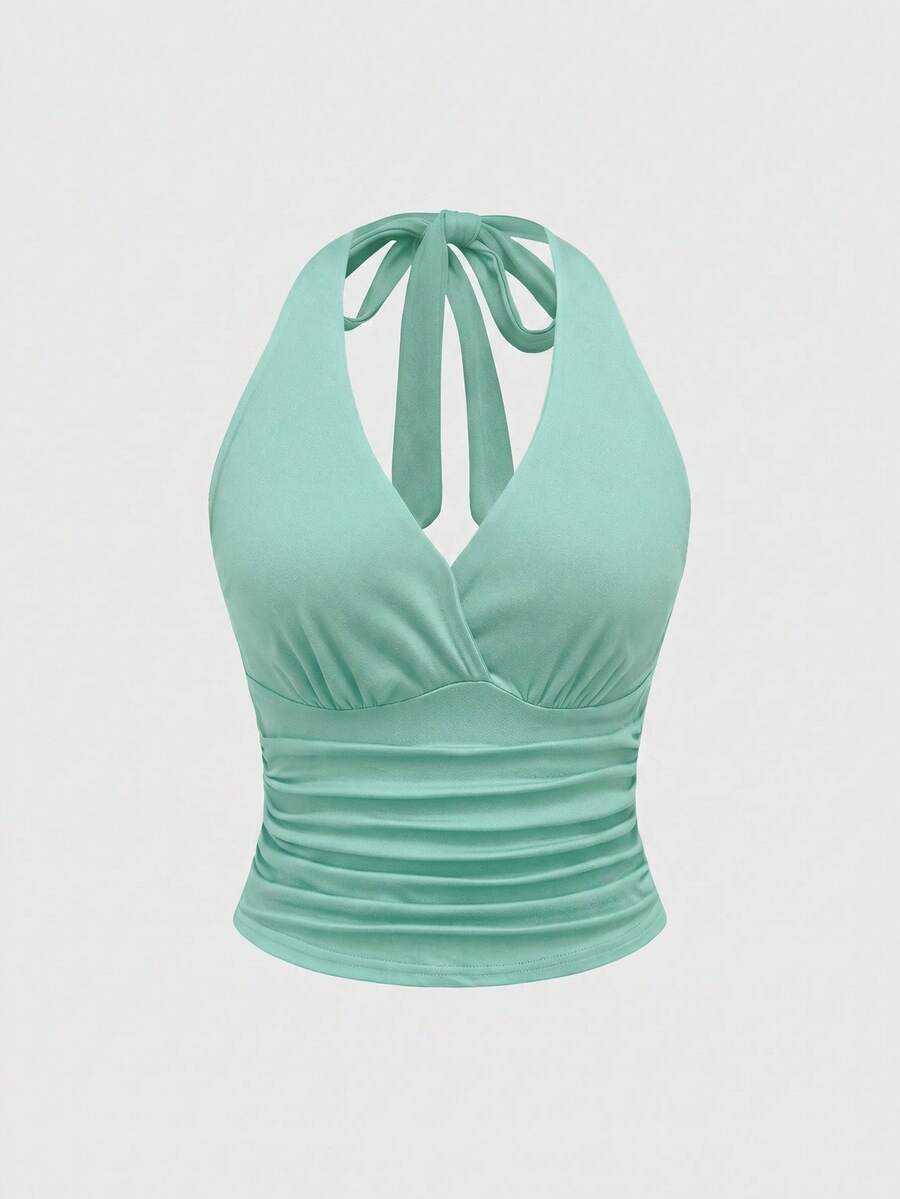 Women's halter crop tank top featuring a backless silhouette and ruched detailing in a slim fit design.
