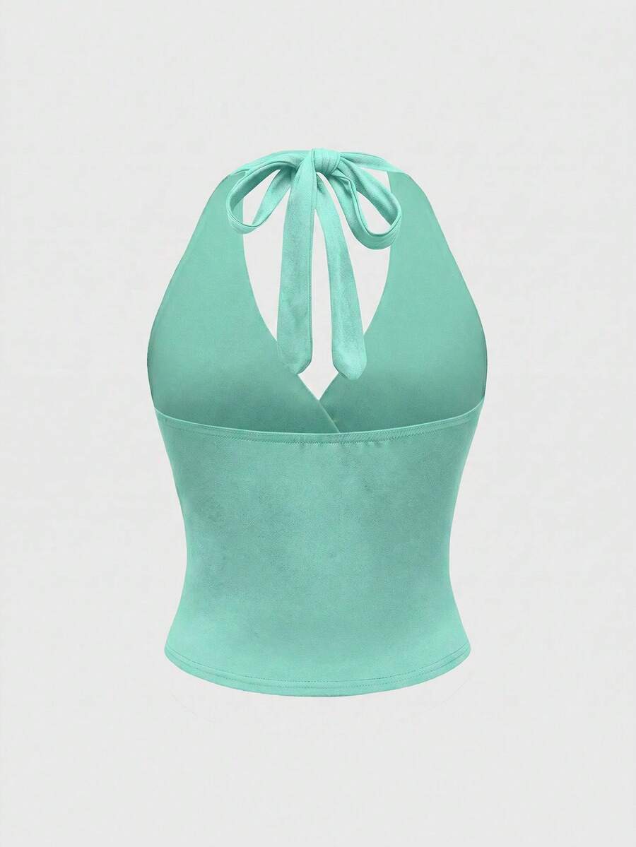 Women's halter crop tank top featuring a backless silhouette and ruched detailing in a slim fit design.