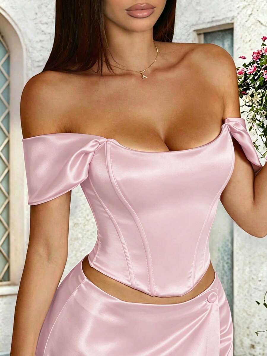 Women's white satin corset crop top with off-shoulder neckline, backless cut, and asymmetrical hem.