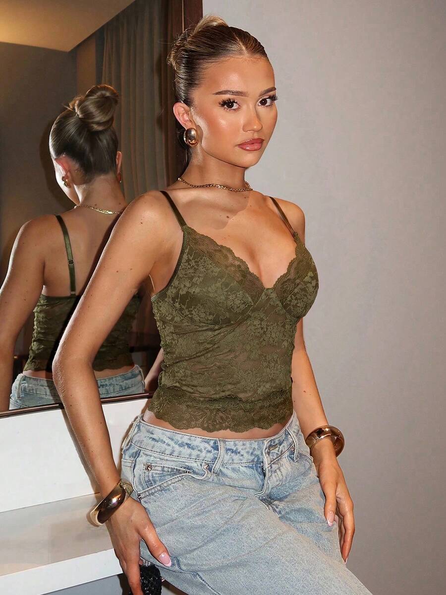 Black floral lace cropped camisole top for women featuring delicate spaghetti straps, cup detail, and semi-sheer contrast lace.