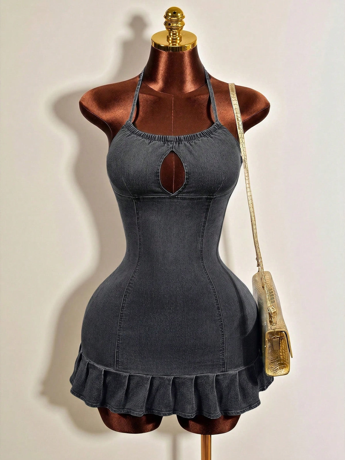 Women's blue denim halter mini dress featuring front cut-out details and a flounce ruffle hem.