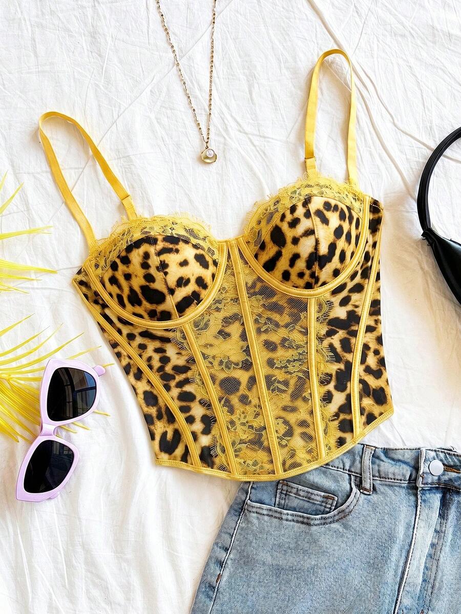 Women's lace bustier camisole top with spaghetti straps, contrast lace, lace-up detail, and an asymmetrical hem in a slim fit design.