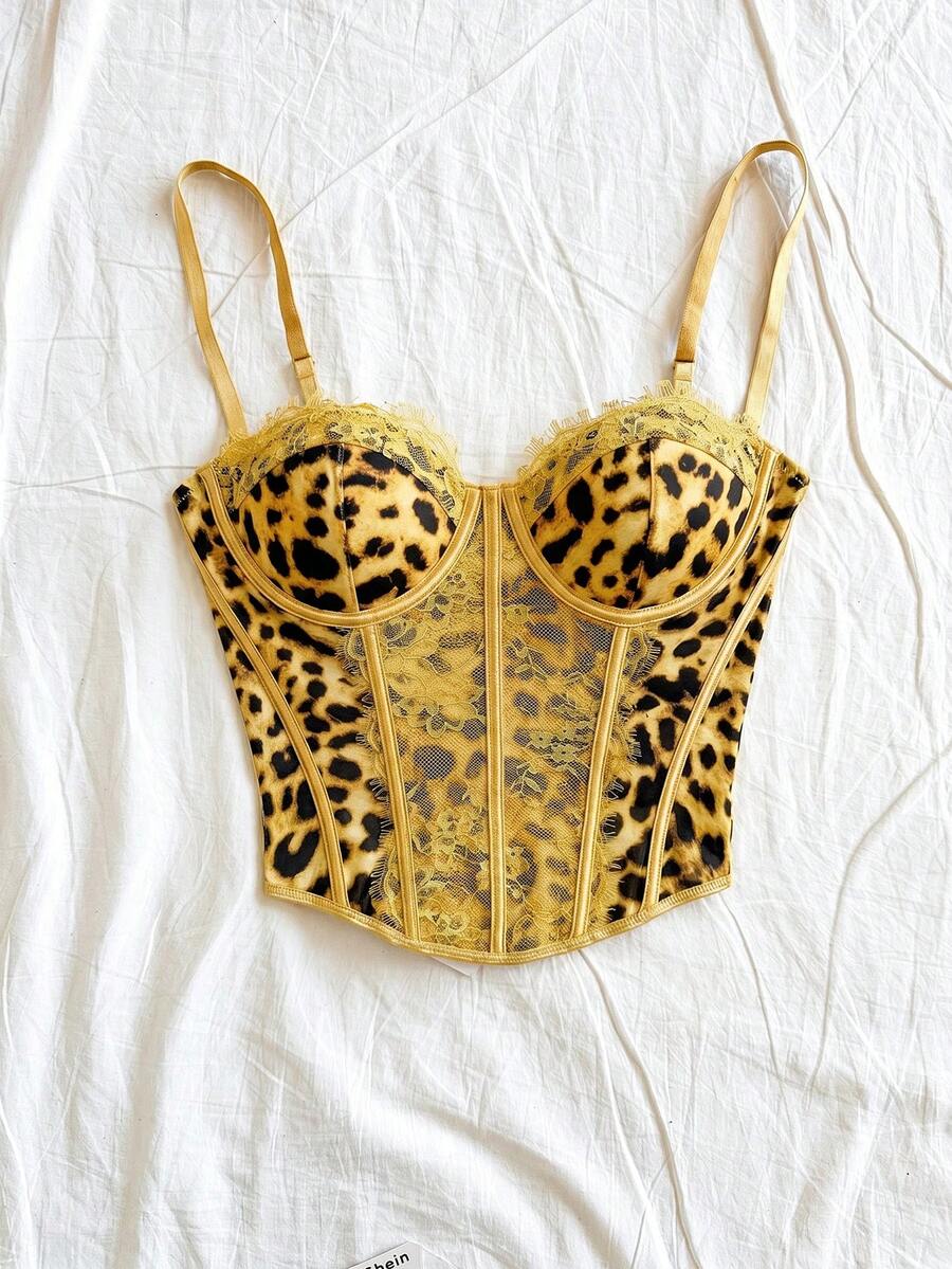 Women's lace bustier camisole top with spaghetti straps, contrast lace, lace-up detail, and an asymmetrical hem in a slim fit design.