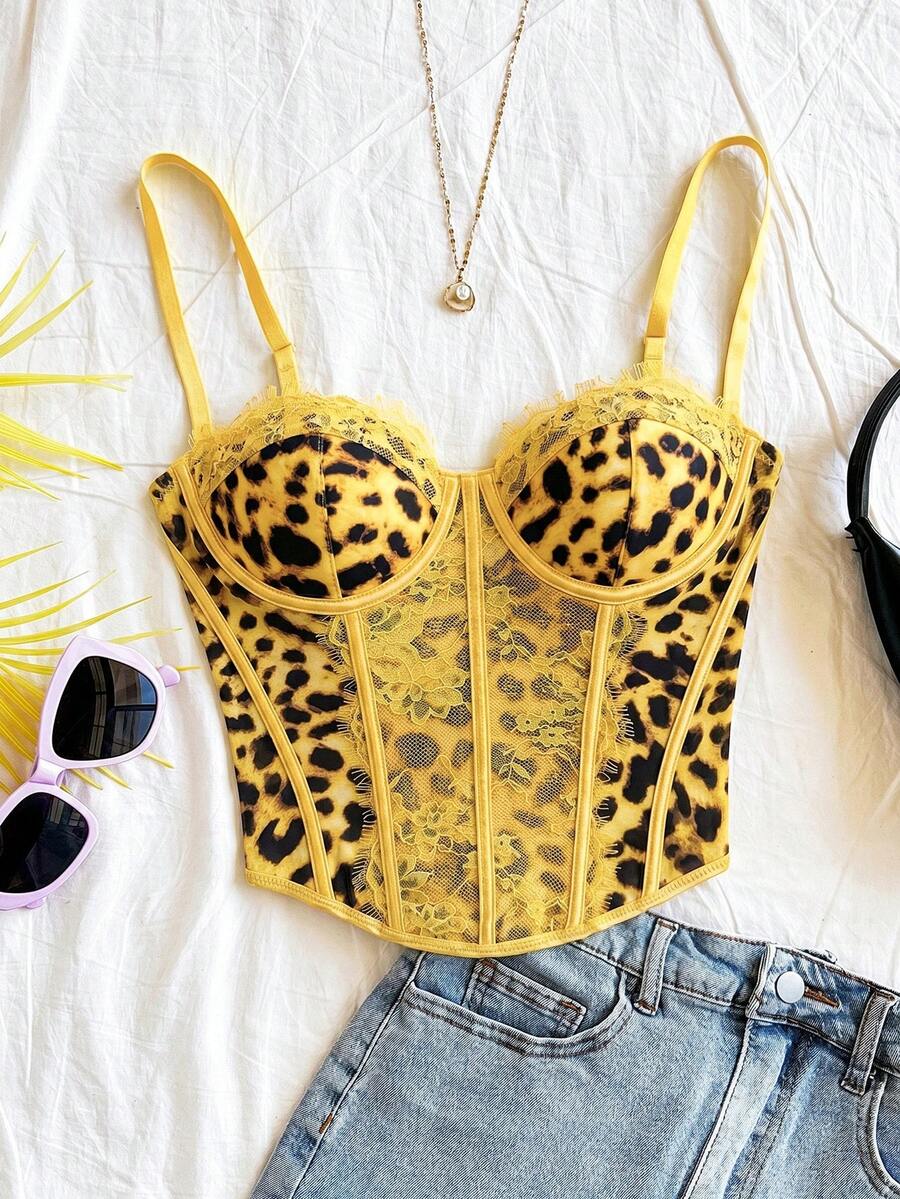 Women's lace bustier camisole top with spaghetti straps, contrast lace, lace-up detail, and an asymmetrical hem in a slim fit design.