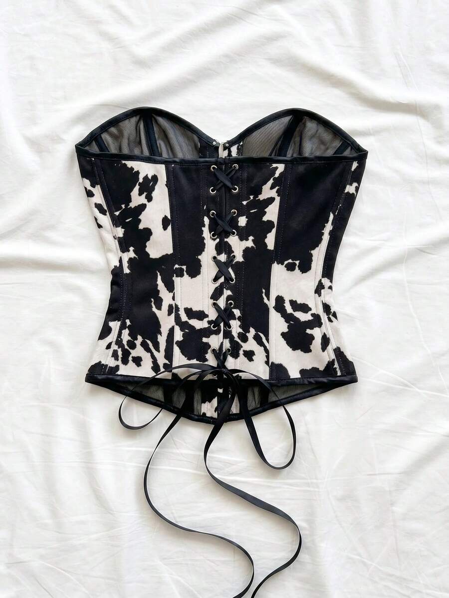 Strapless black lace-up corset top for women with grommet eyelet details, slim fit, lined body, and woven fabric construction.