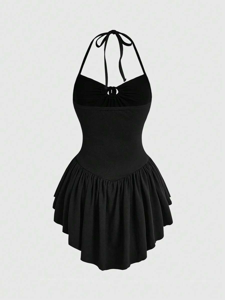 Women's black gothic mini dress featuring a halter neck, cut-out waist, contrast lace details, and an asymmetrical hem.