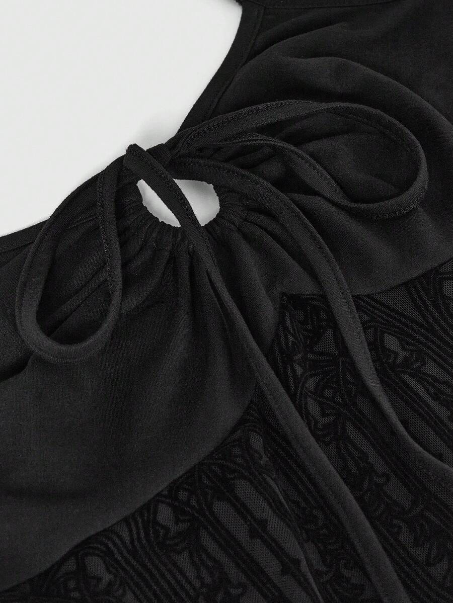 Women's black gothic mini dress featuring a halter neck, cut-out waist, contrast lace details, and an asymmetrical hem.