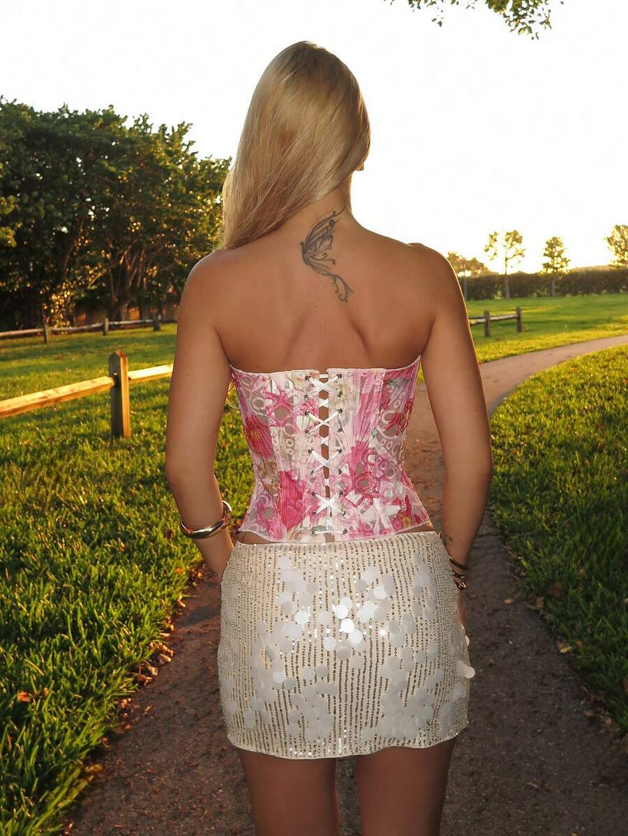 Pink floral lace corset top with a strapless neckline, asymmetrical hem, and slim fit for women.
