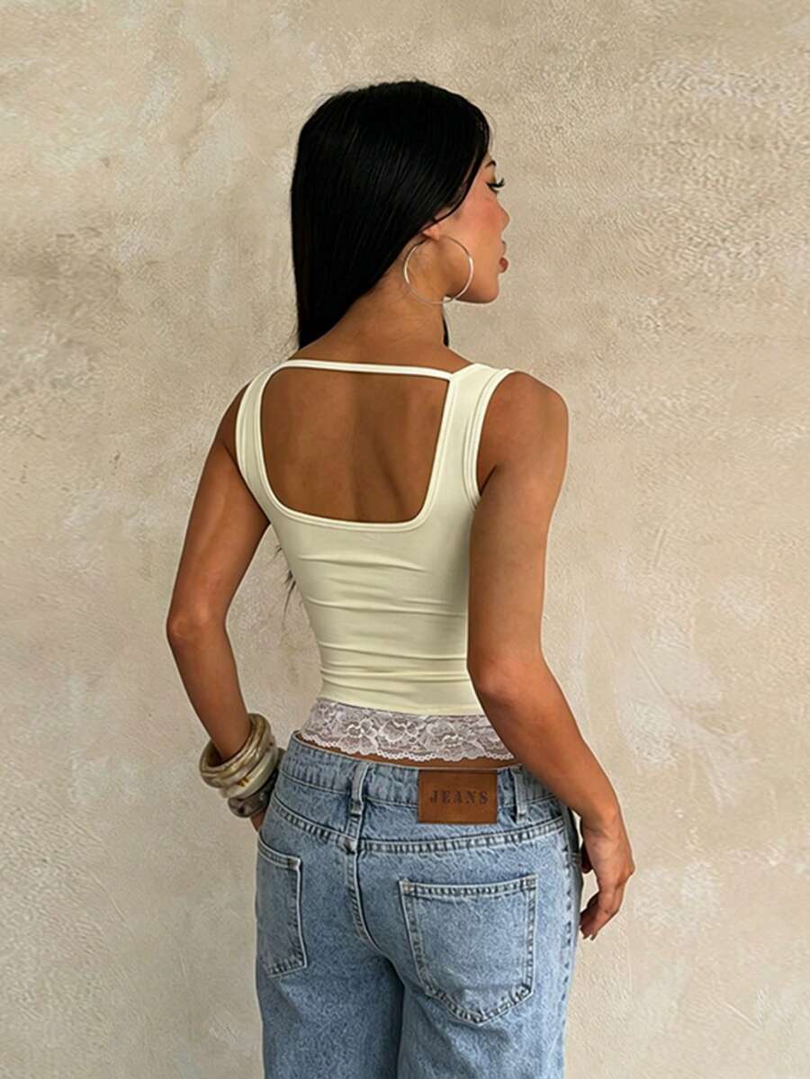 Women's white sleeveless crop top with contrast lace trim, shoulder straps, and a floral graphic print.