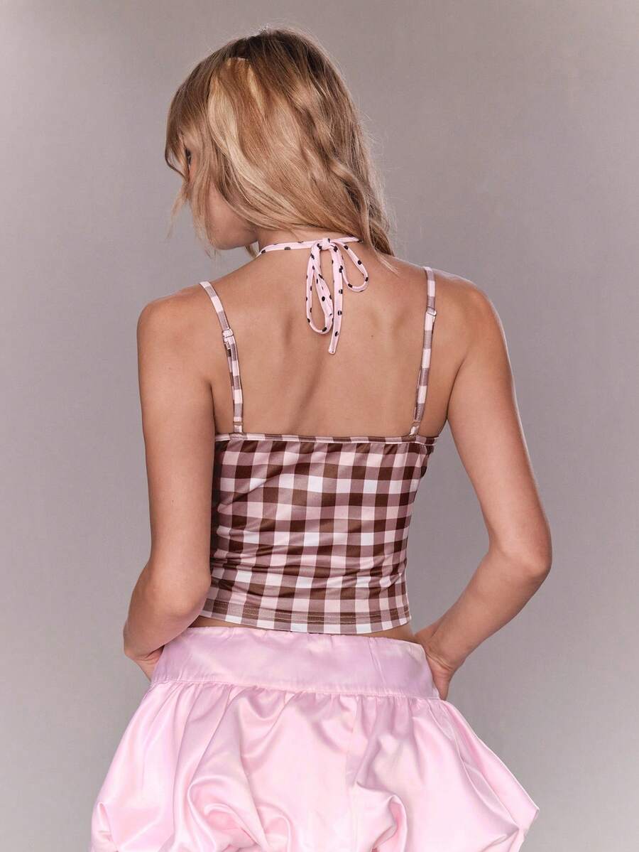 Women's multicolor plaid crop cami top featuring thin spaghetti straps, a front bow detail, and a slim fit knit design.
