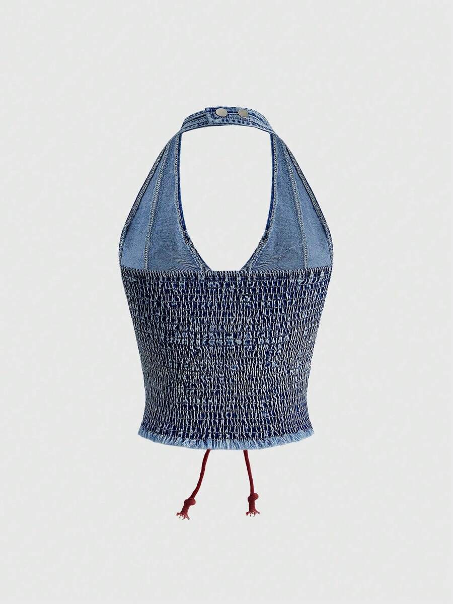 A black Y2K denim halter crop top featuring a backless lace-up grommet eyelet design with a slim fit micro crop length.