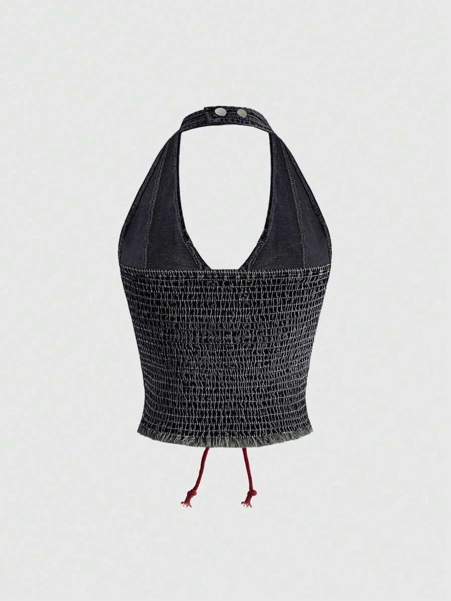 A black Y2K denim halter crop top featuring a backless lace-up grommet eyelet design with a slim fit micro crop length.