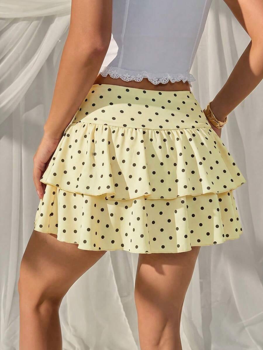 Black low waist knit mini skirt featuring a tiered ruffle hem and skinny high stretch fit.