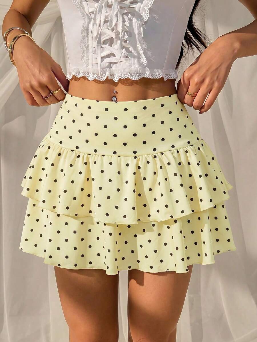 Black low waist knit mini skirt featuring a tiered ruffle hem and skinny high stretch fit.