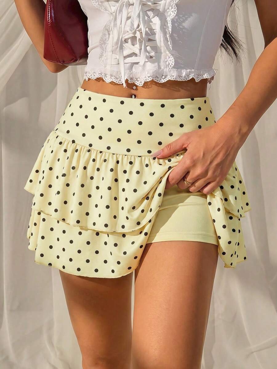 Black low waist knit mini skirt featuring a tiered ruffle hem and skinny high stretch fit.