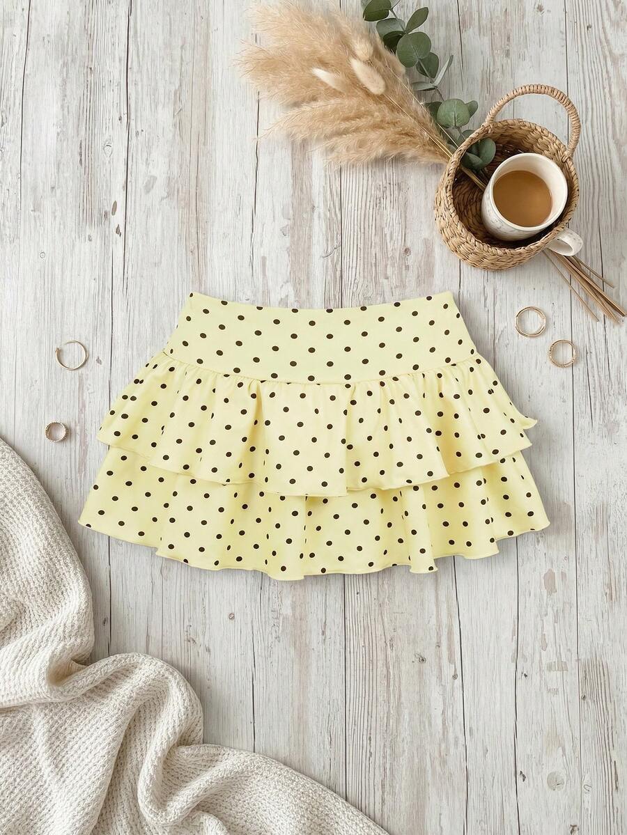 Black low waist knit mini skirt featuring a tiered ruffle hem and skinny high stretch fit.