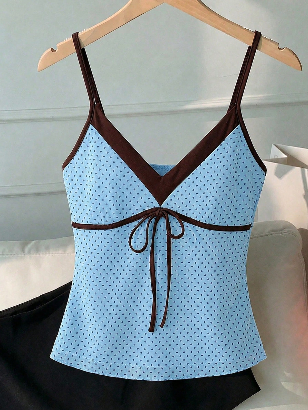 Black and white polka dot tie strap camisole top for women with thin spaghetti straps and slim fit.