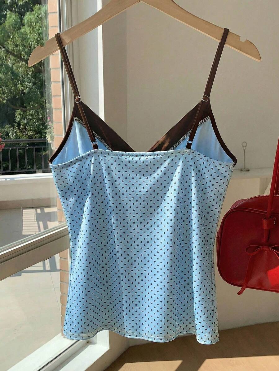 Black and white polka dot tie strap camisole top for women with thin spaghetti straps and slim fit.