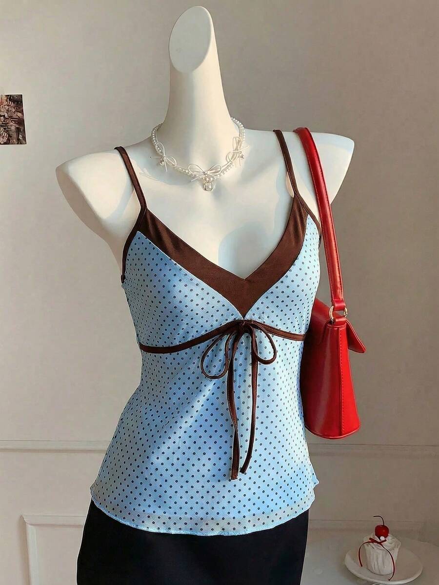 Black and white polka dot tie strap camisole top for women with thin spaghetti straps and slim fit.