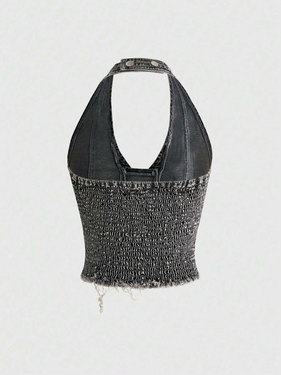 A black Y2K denim halter crop top featuring a backless lace-up grommet eyelet design with a slim fit micro crop length.